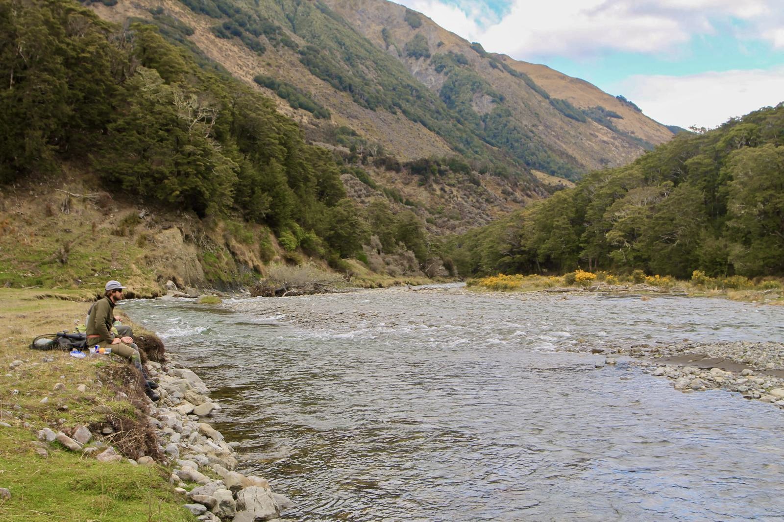 Fly rod rigged and ready on a New Zealand river bank
