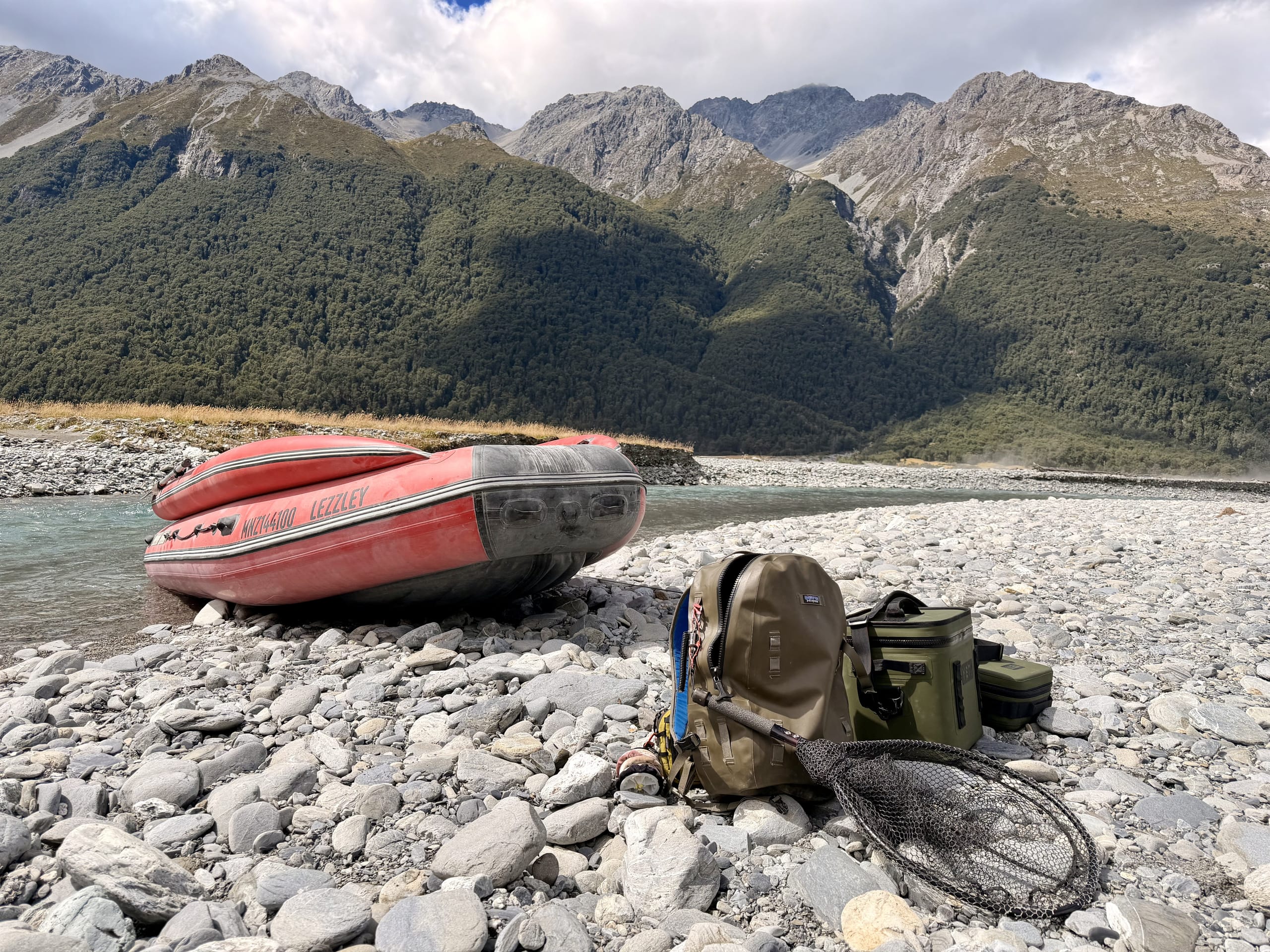 Raft and fishing gear on a remote riverbed deep in the Southern Alps