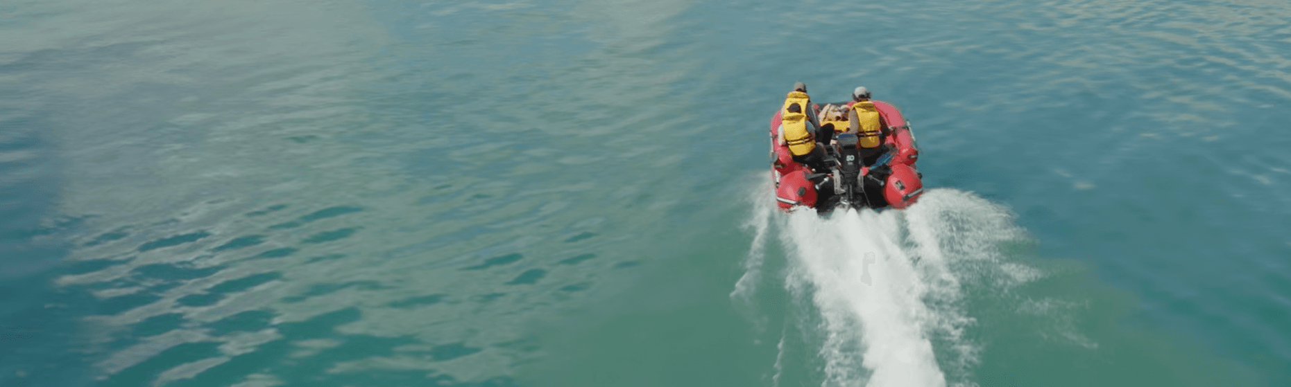 Backcountry taxi jet boat carrying passengers across clear open water
