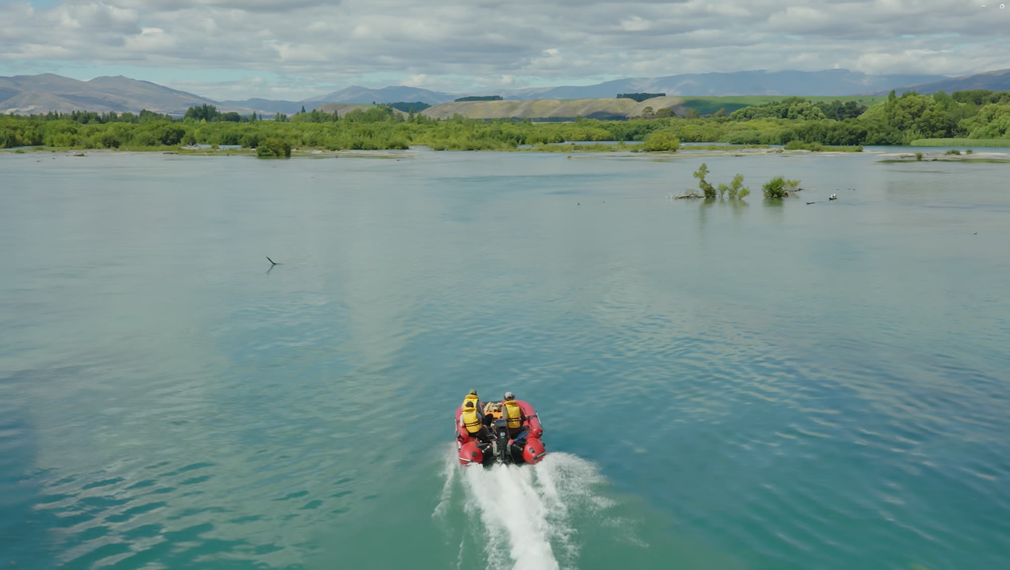 The SIB River Jet Lux cruising open water toward the mountains