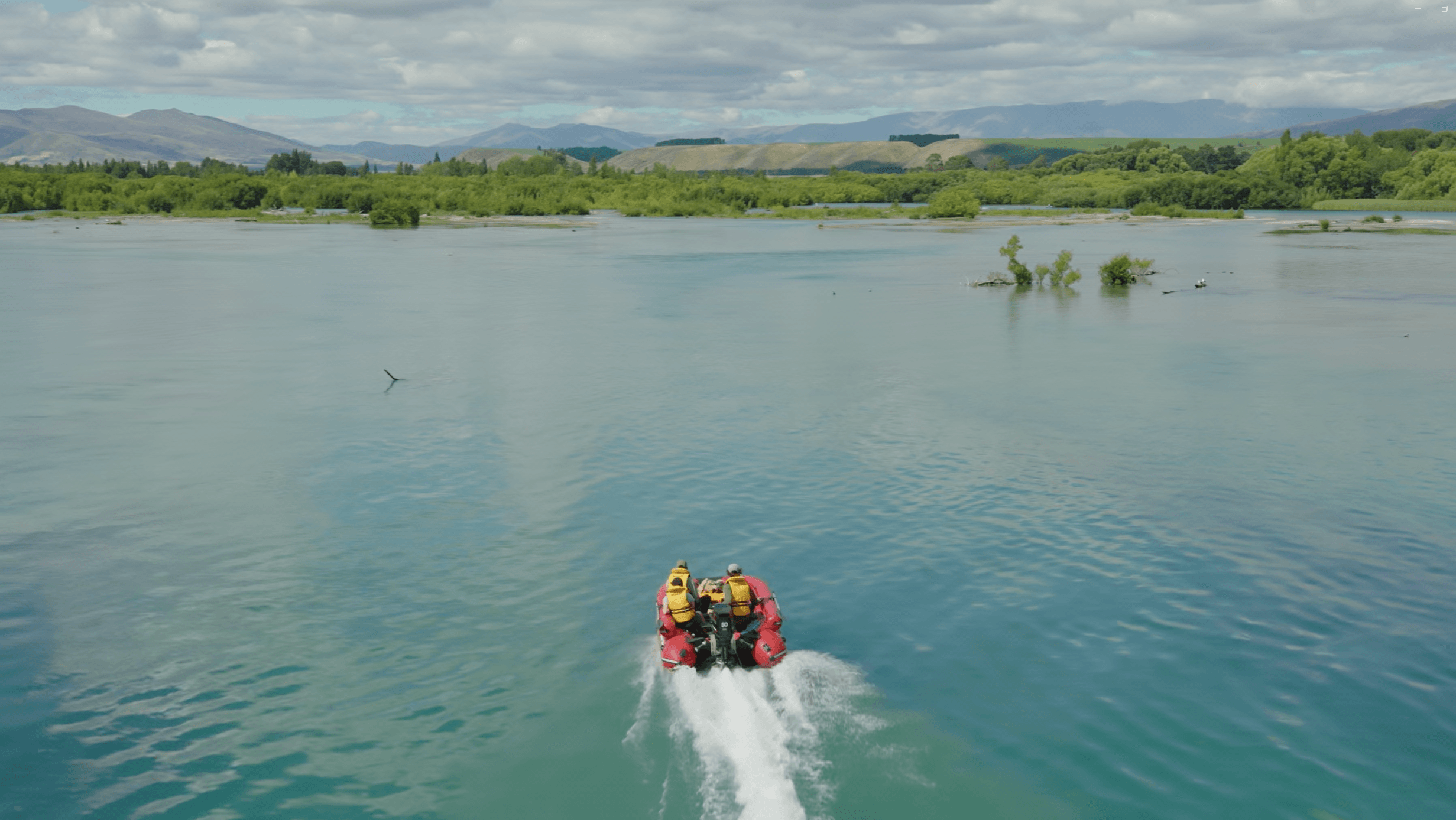 Backcountry taxi jet boat carrying passengers across clear open water